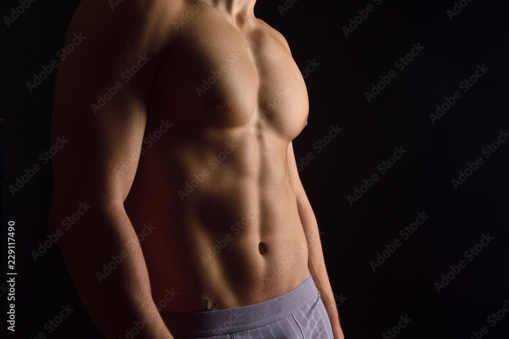 naked body of a man on black background naked body of a man on black background