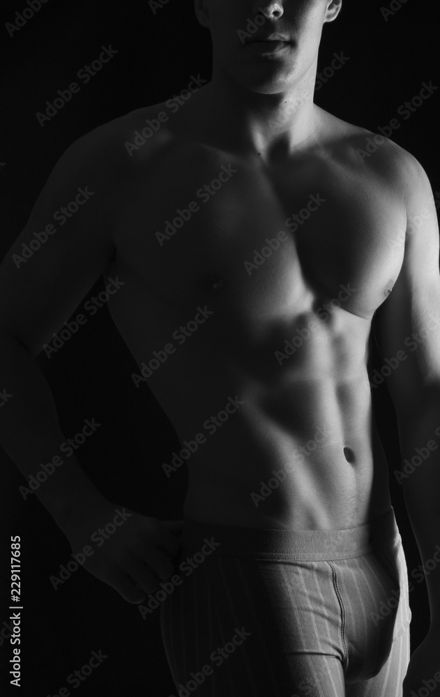 naked body of a man on black background naked body of a man on black background