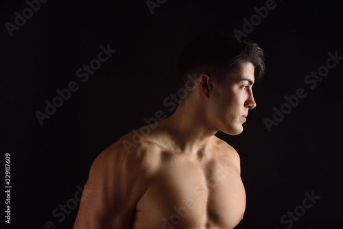portrait of a man without clothes black background