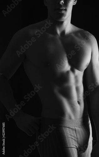 naked body of a man on black background © curto