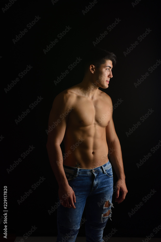 portrait of a man with jeans black background portrait of a man with jeans black background
