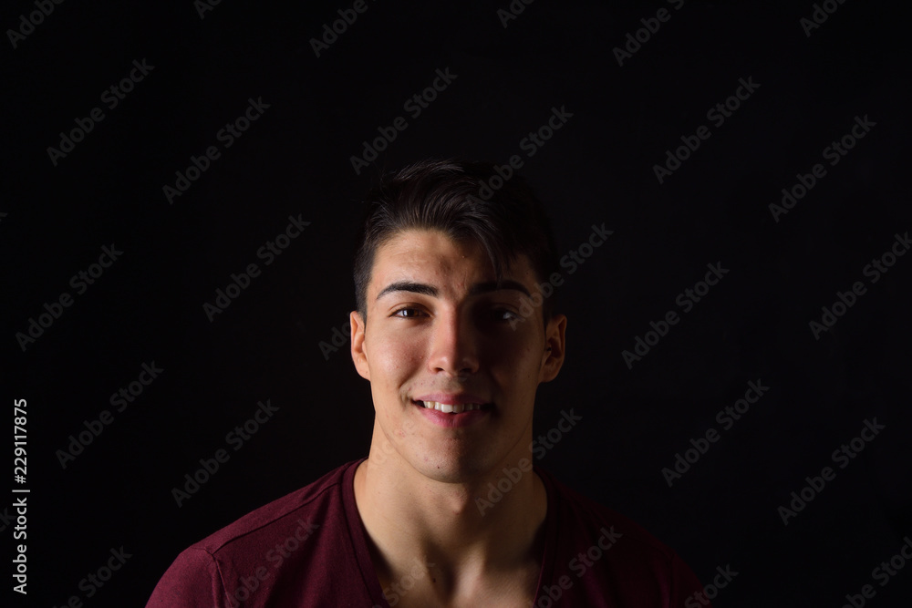 portrait of a young man on black background