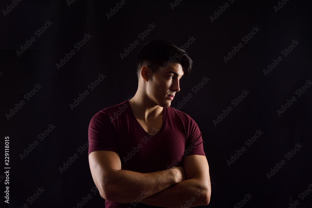 portrait of a young man on black background portrait of a young man on black background