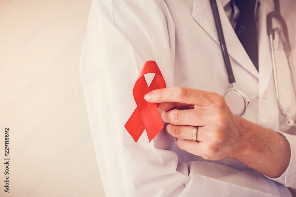 Doctor hand holding red ribbon, world AIDS day - obrazy, fototapety, plakaty 