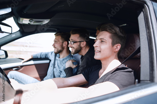 a group of boys rides and looks directly at the car © ASDF