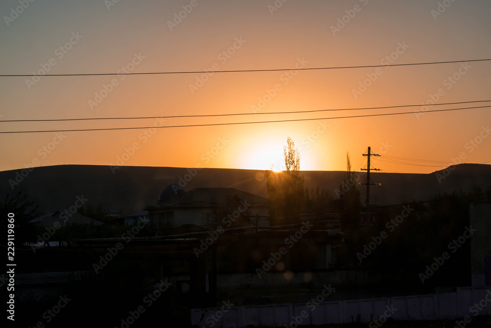 sky,sun,clouds,landscape,nature,sunrise,cloud,evening,blue,morning,summer,red,night,beautiful,dawn,dusk,view,countryside,beauty,horizon,silhouette,field,trees,radiant,bright,pink,yellow,rural,village,