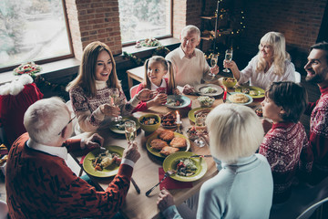 High above angle view of noel diverse family gathering. Cheerful