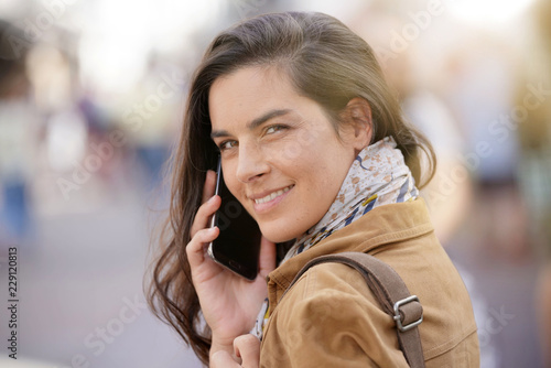 Woman in the street talking on phone