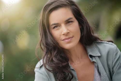 Portrait of attractive brunette woman, outdoor scene