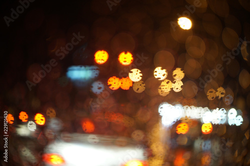 Rainy night traffic light - selective focus on the raindrop,abstract bokeh of light