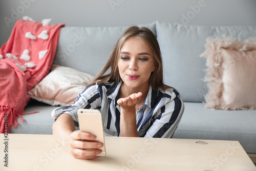 Young woman with mobile pho...