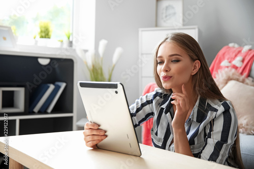 Young woman with tablet com...