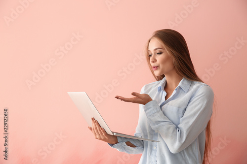 Young woman with laptop hav...
