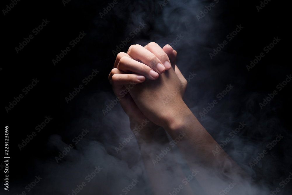 Praying hands over dark background Stock Photo Adobe Stock