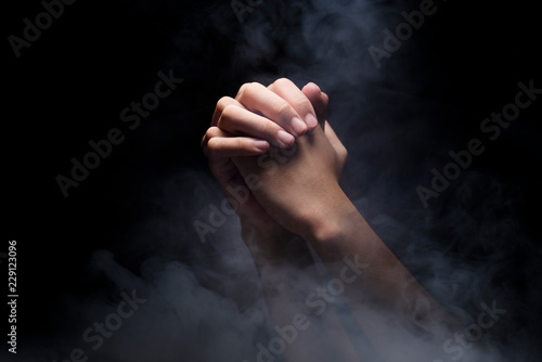 Fotografie, Tablou Praying hands over dark background