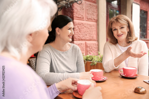 Beautiful mature women drin...