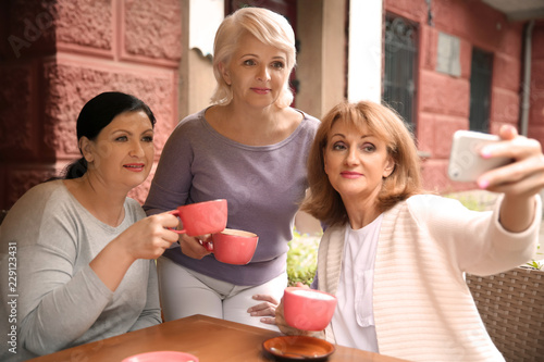 Beautiful mature women drin...