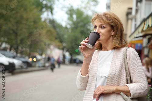 Beautiful mature woman drin...