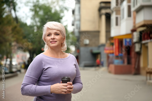 Beautiful mature woman drin...