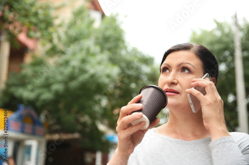 Beautiful mature woman drin...
