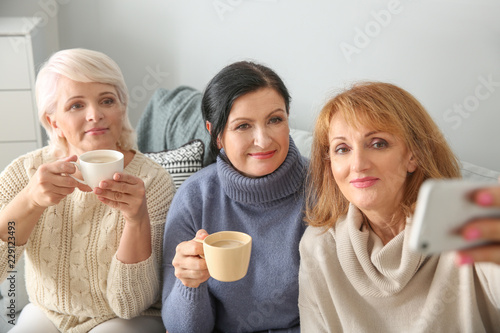 Beautiful mature woman drin...