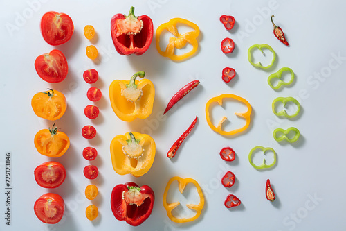 Flat lay composition with tomatoes and peppers on white background