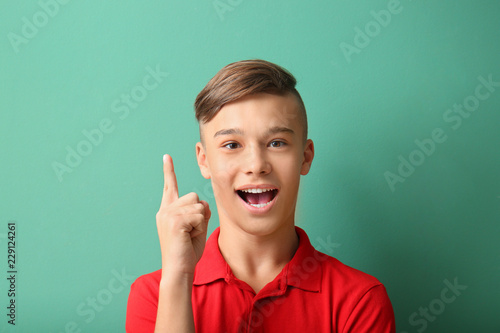 Teenage boy with raised ind...