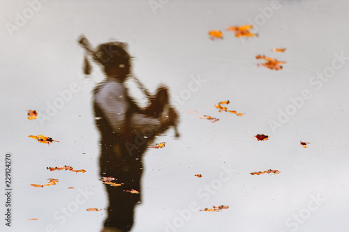 Reflected in water with leaves of a bagpiper photo