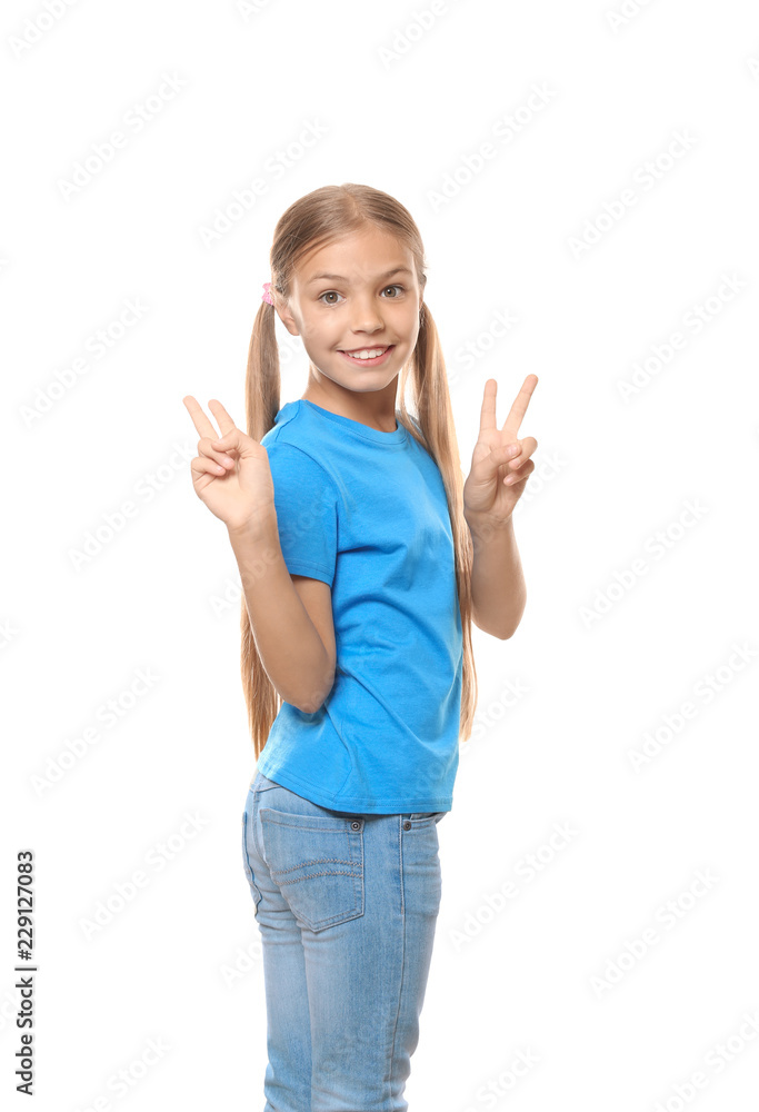 Little girl in t-shirt showing Victory gesture on white background Little girl in t-shirt showing Victory gesture on white background