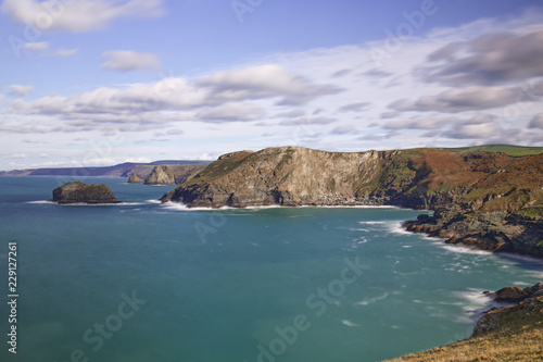 A scenic view of the west Cornwall coast taken From Barras Nose near Tintagel and Bossiney on a sunny Autumn day, using a slow shutter speed to blur cloud and water movement