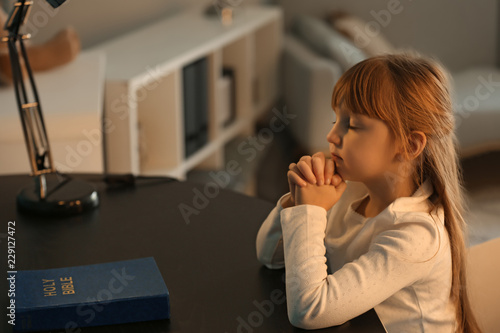Little girl praying at dark...