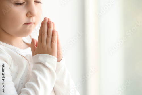 Little girl praying at home
