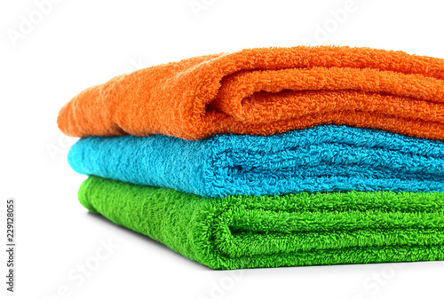 Stack of bright soft towels on white background