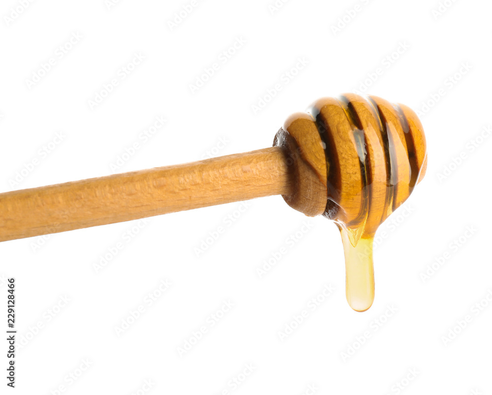 Honey dripping from dipper on white background Honey dripping from dipper on white background