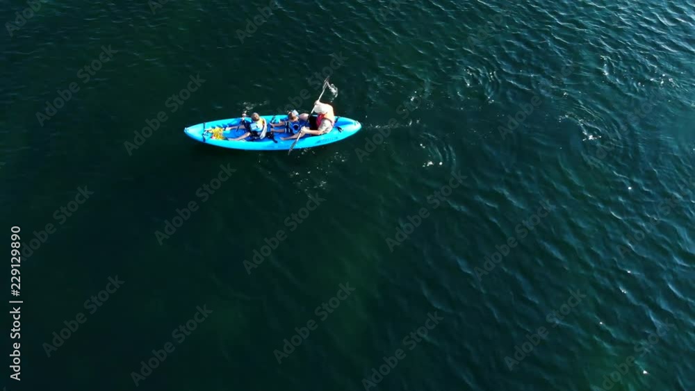 Aerial High Shot Of A Father And His Boys Floating On Ocean Kayak Aerial High Shot Of A Father And His Boys Floating On Ocean Kayak