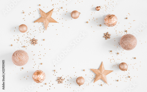 Christmas composition. Christmas golden decorations on pastel gray background. Flat lay, top view, copy space