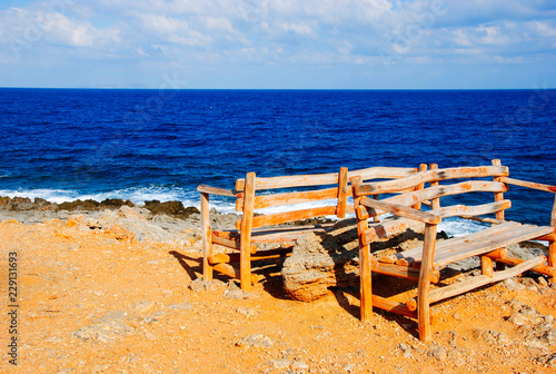old vintage bench near the rocky coast of Sissi on Crete in Greece