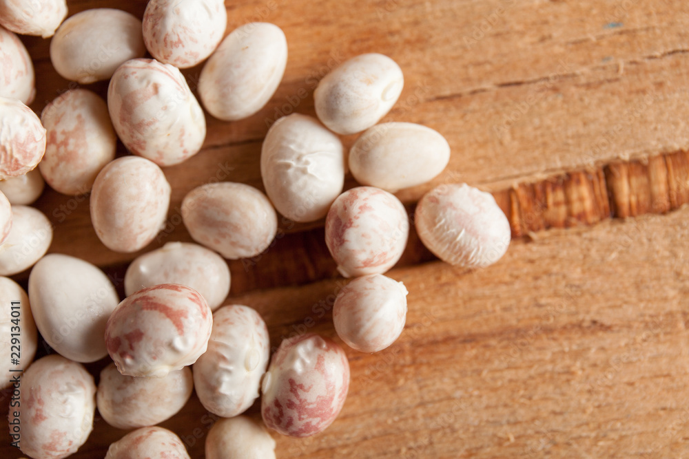 White beans close up on wood desk White beans close up on wood desk