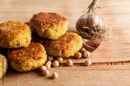 Fresh falafel balls on a wooden cutting board photo