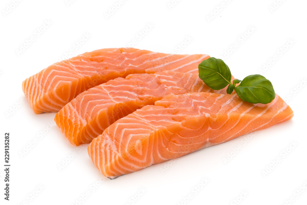Fresh salmon fillet with basil on the white background.