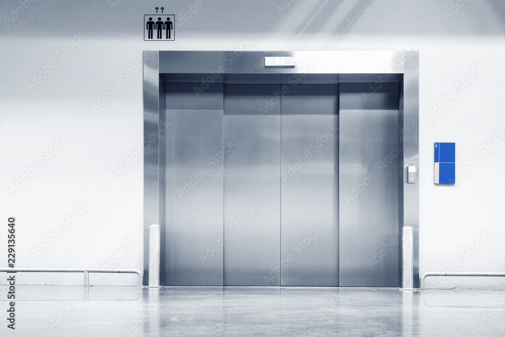 Metallic Doorway of Modern Elevator in Office Building, Architecture Contemporary of Door Lift and Interior Lighting Decorative. Electronic Control Panel and Flooring Symbol Signage of Elevator Metallic Doorway of Modern Elevator in Office Building, Architecture Contemporary of Door Lift and Interior Lighting Decorative. Electronic Control Panel and Flooring Symbol Signage of Elevator