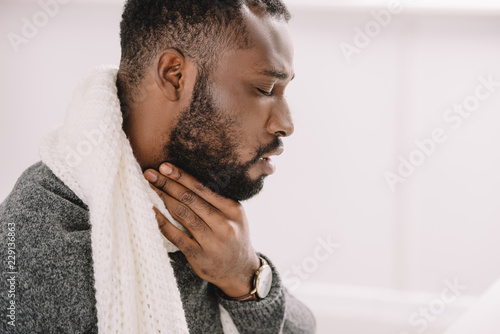 diseased african american man having sore throat photo
