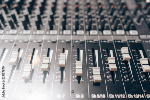 Audio equalizer close up. Studio audio volume mixer. Professional audio equipment.