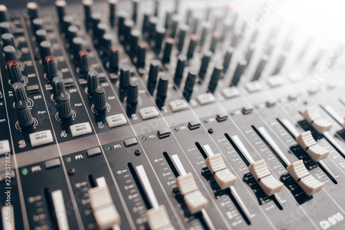 Audio equalizer close up. Studio audio volume mixer. Professional audio equipment.