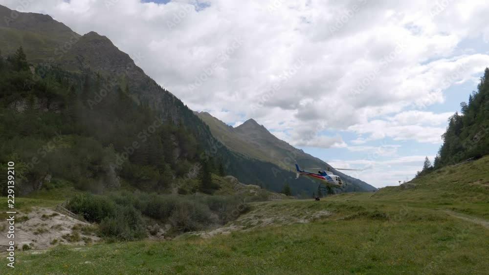 A rescue helicopter taking off in mountain A rescue helicopter taking off in mountain