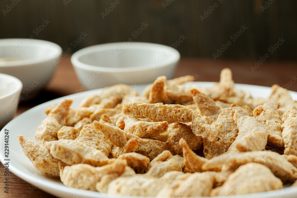 Raw dry soya meat chunks on a white plate, macro shot Raw dry soya meat chunks on a white plate, macro shot