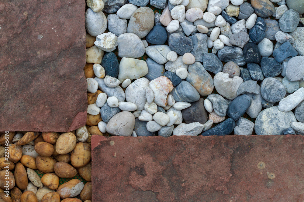 Background of textured from natural multicolor pebbles and old red sandstone in the gardens Background of textured from natural multicolor pebbles and old red sandstone in the gardens