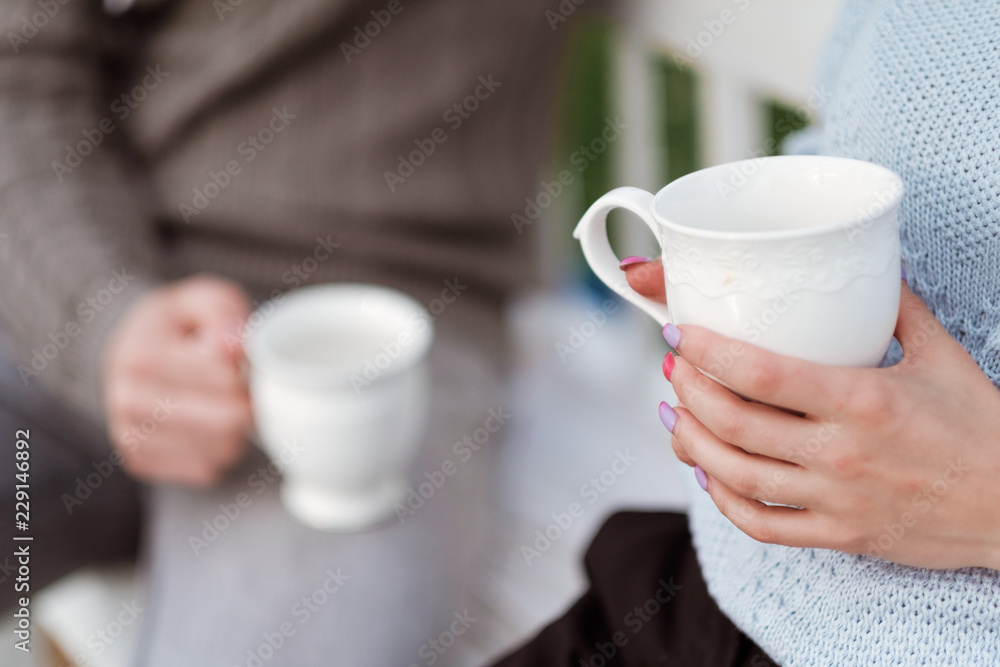 Friends drink tea and have a good time on the terrace of a country house. Friends drink tea and have a good time on the terrace of a country house.