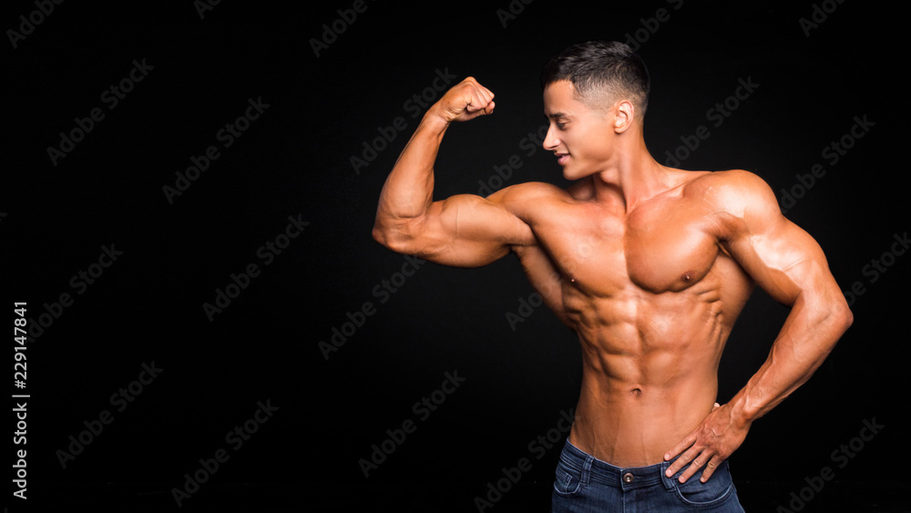 Fashionable masculinity. Handsome young man posing on a dark background.