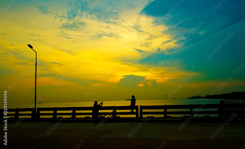 Shadow people with views to the sun near the horizon.